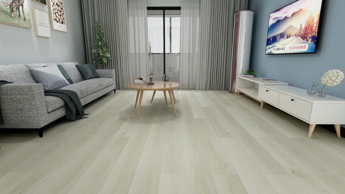 Pale greige SPC floor in a family living room with blue walls