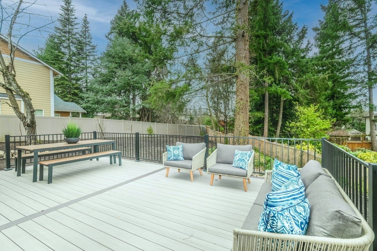 Composite deck with lounge furniture overlooking a garden